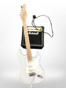 A Shine Stratocaster style electric guitar and a Marshall MG series amplifier with lead