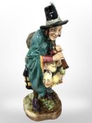 A Royal Doulton figure, 'The Mask Seller' HN 2103.