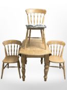 A modern pine farmhouse style drop leaf table and three chairs