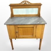 An Edwardian marble topped tiled backed washstand,