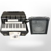 A Hohner Electravox De Luxe piano accordion with instructions, in travel case,