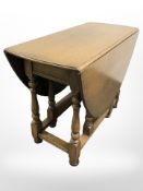 A Pratts of Bradford oak drop leaf dining table,