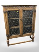 A carved oak leaded glass cabinet,