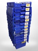 Twelve stackable plastic storage boxes with folding lids,