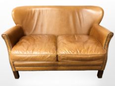A John Lewis Halo studded tan leather two seater settee,