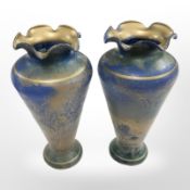 A pair of 20th-century iridescent blue glass vases in the manner of Loetz, height 18.5cm.