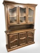 A reproduction Colonial style triple door dresser,