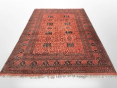 A Turkoman carpet, Afghanistan, the eight black medallions within a floral madder field,