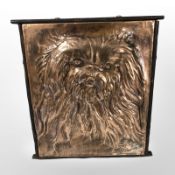 A copper-plated relief panel depicting Pekingese dog,