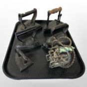 Five antique irons and a further chrome example.