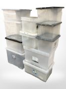 Approximately 14 plastic storage boxes.