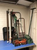A Black & Decker electric garden mower, a push-along garden scarifier, various garden tools,