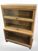 An Edwardian Globe-Wernicke glazed oak three tier stacking bookcase, 85cm w x 36cm d x 116cm h.