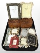 A group of modern photograph frames and a birds eye maple trinket box.