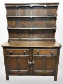 An Ercol stained elm dresser, 122cm w x 47cm d x 167cm h.