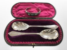 A cased pair of silver spoons, London marks, together with a silver and hardstone bangle.