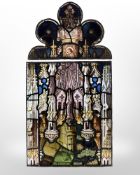 A stained glass panel and further ogee panel above,