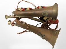 Two copper and brass bugles.