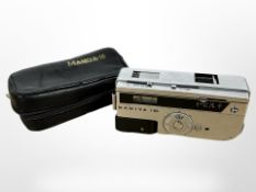 A Mamiya 16 camera, in leather slip cover.