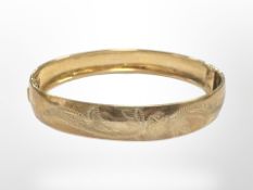 A 9ct gold engraved bangle, inner width 6cm. CONDITION REPORT: 11.