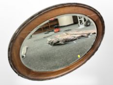 A Victorian mahogany oval mirror, 87cm width.