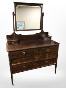 A late Victorian mahogany and satinwood strung four drawer mirror back dressing table,