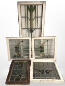 Five various Victorian stained and leaded glass windows in painted surrounds,