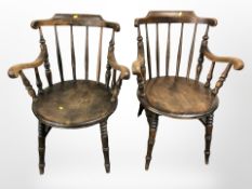 A pair of Edwardian beech spindle back armchairs.