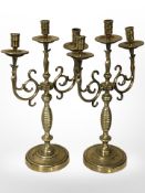 A pair of ornate brass triple-sconce candelabra, height 42cm.