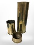 Three brass shell cases, tallest 29cm.