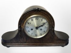 An early-20th century oak eight day mantel clock with silvered dial, width 50cm.