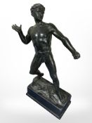 A patinated metal statue of a semi-nude Greek figure, height 34cm.