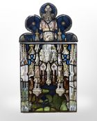 A stained glass panel and further ogee panel above,