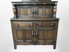 An Ercol stained elm sideboard, 123cm w x 47 d x 124 h.