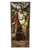 A stained glass panel depicting Christ amongst foliage, within plain narrow borders, 145cm by 61cm.