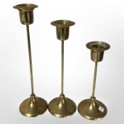 A set of three graduated brass candlesticks, tallest 23cm.