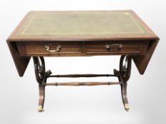 A reproduction mahogany drop leaf sofa table in the Regency style,
