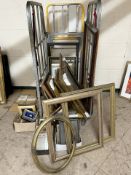 Approximately 70 various mostly gilt picture frames, some containing colour prints,
