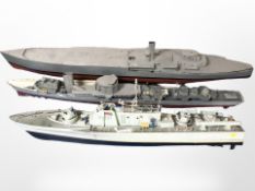 Three remote-controlled scale model destroyers in partially built condition, largest 145cm long.