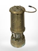 A Welsh brass miner's lamp.