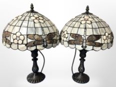 A pair of Tiffany-style patinated metal table lamps with dragonfly shades, height 45cm.