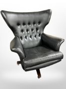 A vintage G Plan model 6250 Blofeld black leather swivel armchair