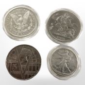 A George VI five shillings coin 1951, a 2001 five pound coin, an American silver dollar 1880,
