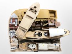 A group of remote control scale model boat hulls,