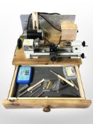 An Emco Unimat 3 miniature lathe mounted to a pine box, fitted a drawer.