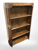 A 1930's oak linen fold open bookcase, 70cm w x 21cm d x 112cm h.