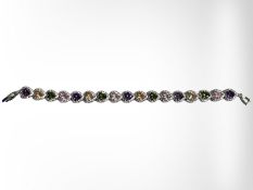 A white metal bracelet set with heart shaped multicoloured synthetic stones,