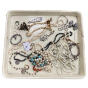 A group of costume jewellery, beaded necklaces, stone polished bangle,