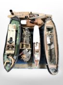 A group of remote control scale model boat hulls,