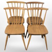 A set of four Ercol stained elm and beech spindle back dining chairs.